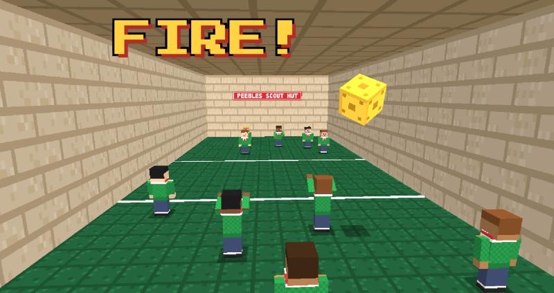 The Fire! game: a yellow ball flies through the air as blocky Minecraft-style Cub Scouts in green jumpers scatter across the hall to catch it, under the word FIRE!